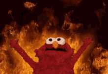 Elmo from Sesame Street raising his arms in front of a background of animated flames.
